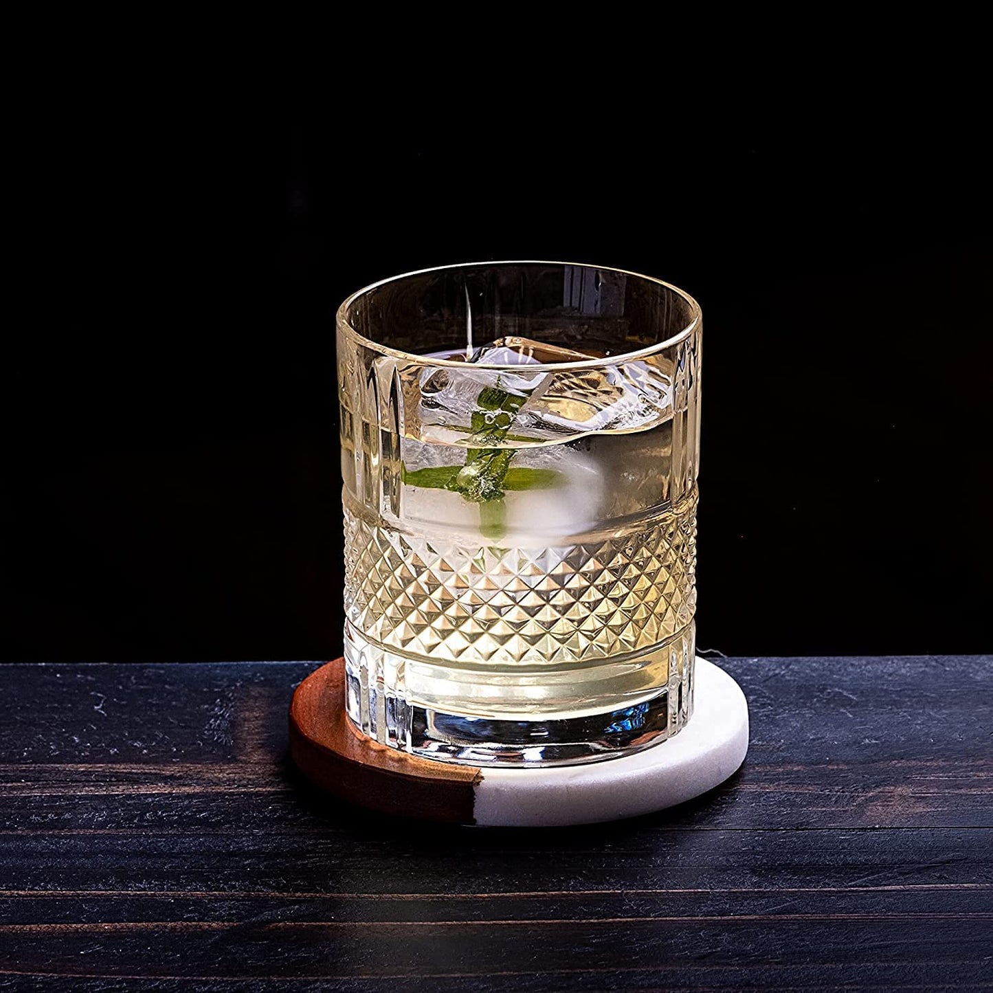 Clear glass with a cocktail on a dark surface