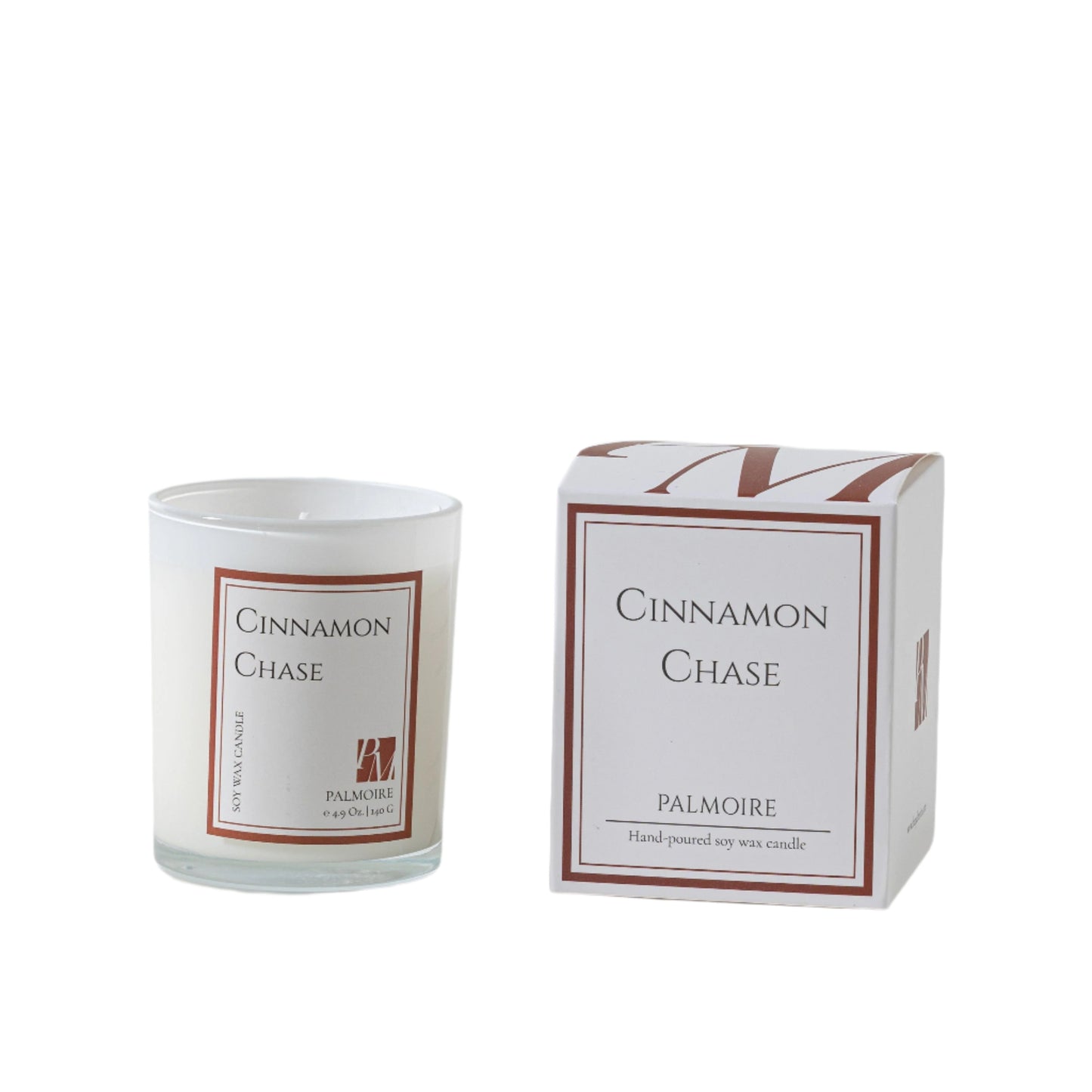 Candle labeled 'Cinnamon Chase' by Palmoire next to its packaging on a light background