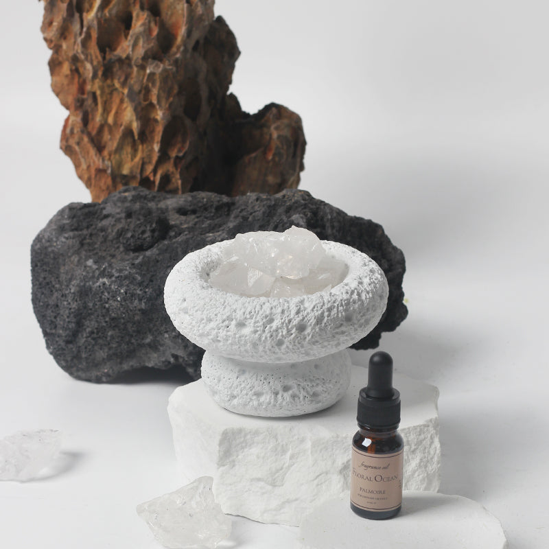 White Moon Diffuser with a bottle of Floral Ocean fragrance on a light background