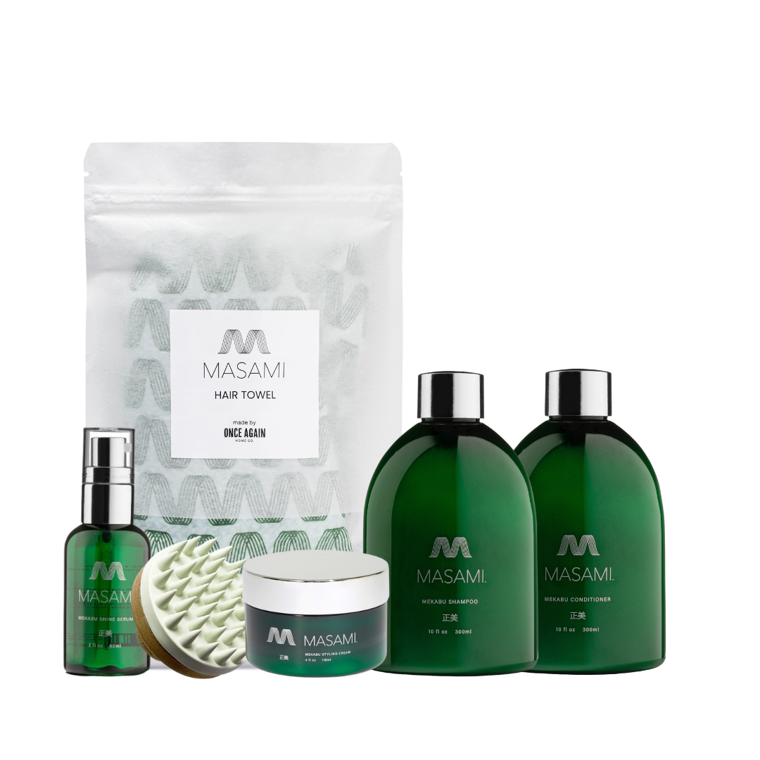 Set of Masami hair care products including shampoo, conditioner, serum, and towel on a white background