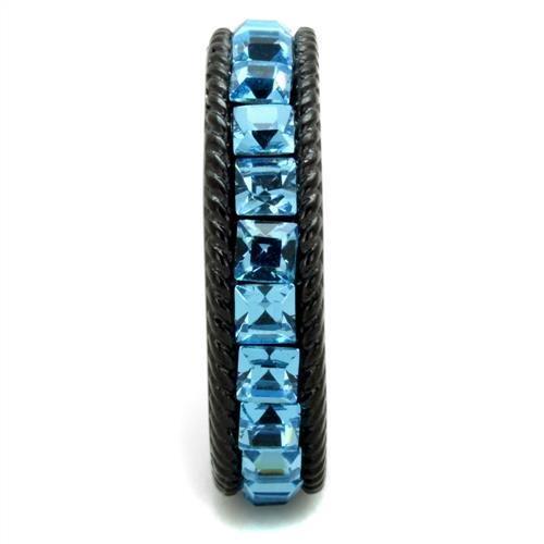 Ring with blue gemstones and black band on a white background