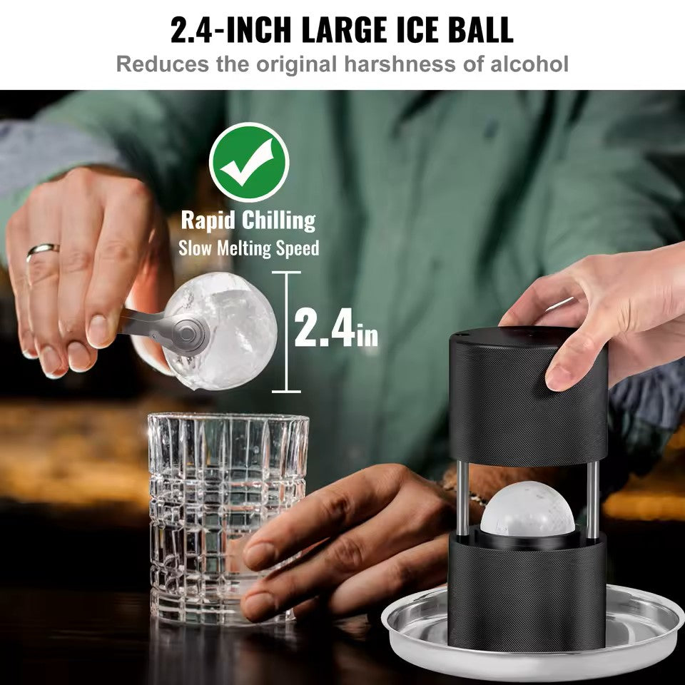 Person using a black ice ball maker to create a large ice ball in a glass.
