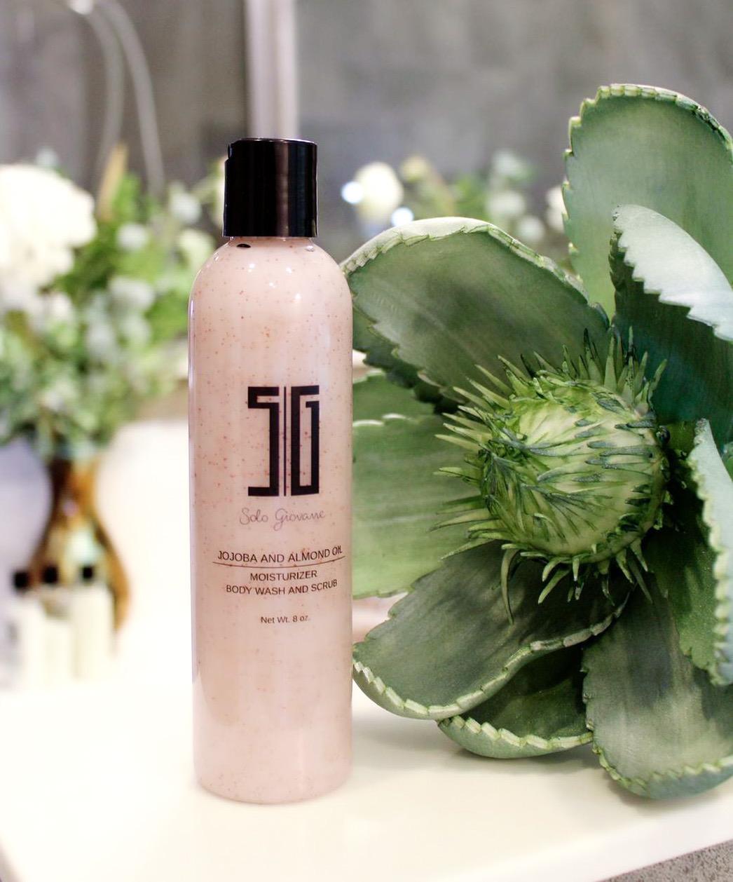5G Body wash bottle with green plant in the background