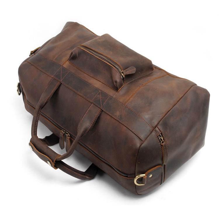 Brown leather duffel bag on a white background