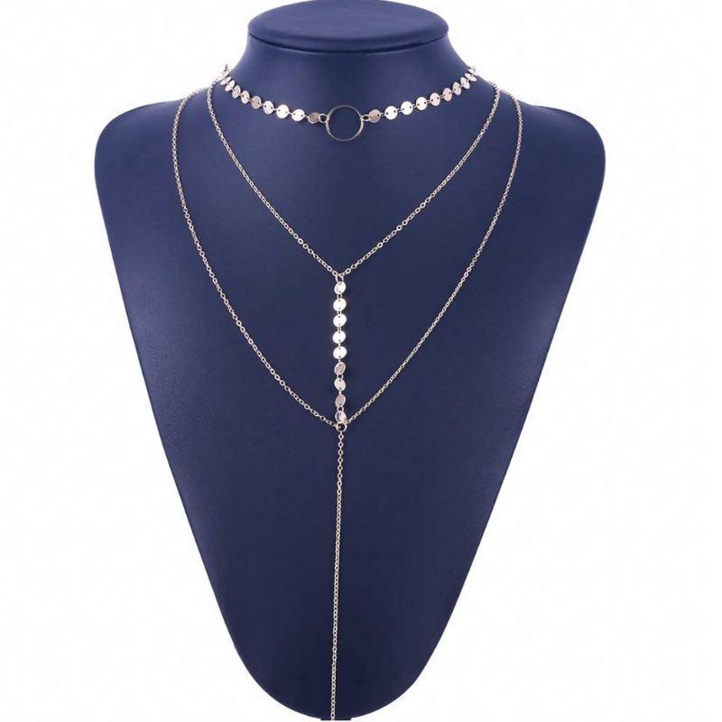 Silver necklace on a blue mannequin bust