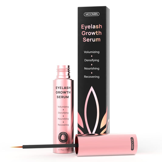 Eyelash growth serum with packaging and applicator on a white background