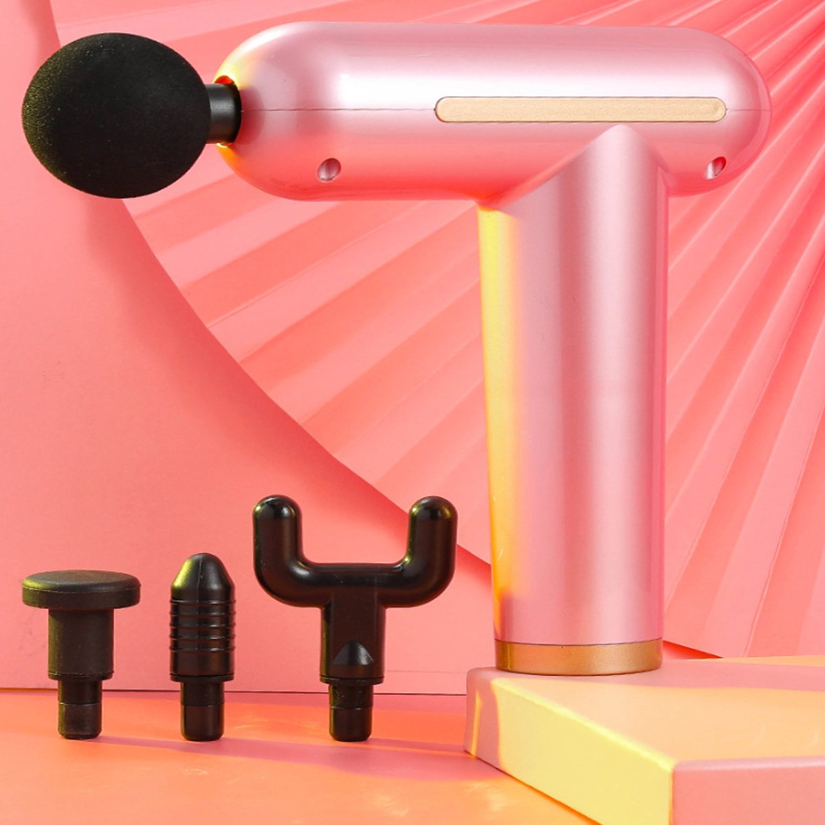 Pink handheld massager with black attachments on a pink geometric background