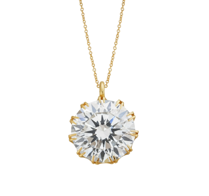 Gold necklace with a large diamond pendant on a white background