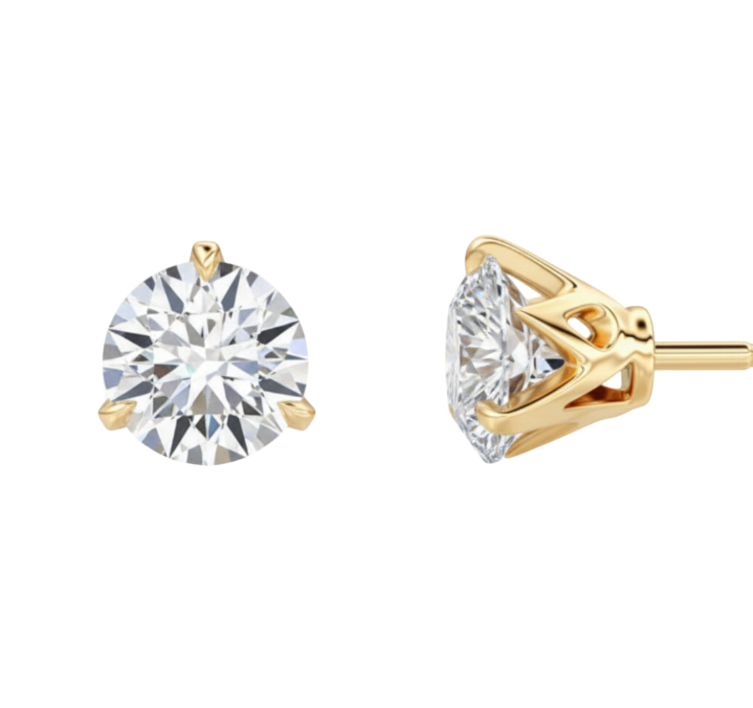 Gold earrings with clear gemstones on a white background