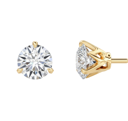 Gold earrings with clear gemstones on a white background