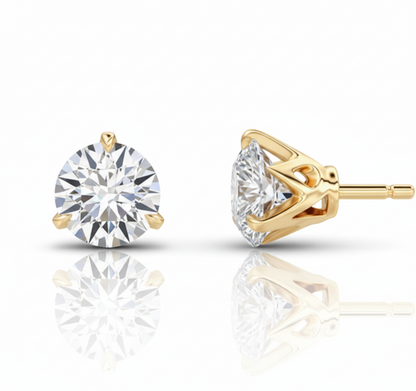 Gold stud earrings with clear gemstones on a white background
