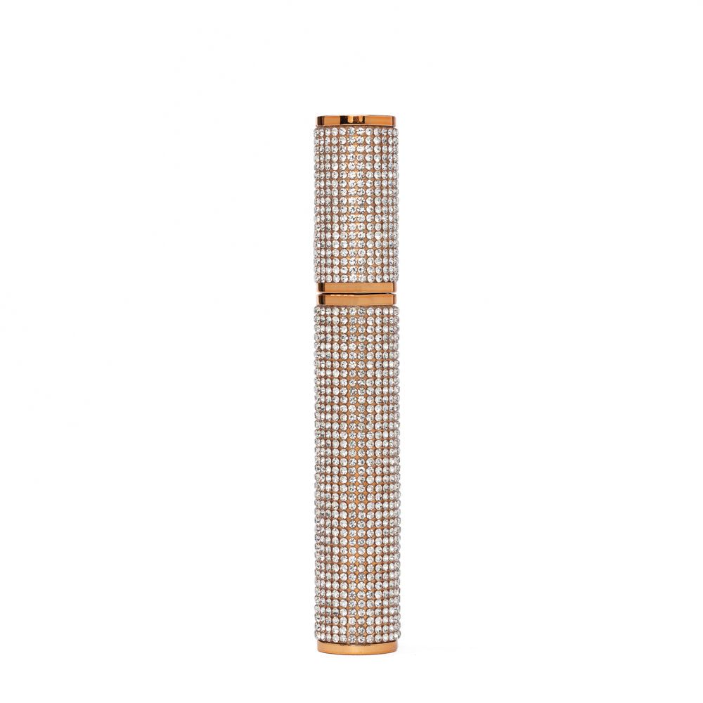 Decorative mascara with rhinestone embellishments on a white background