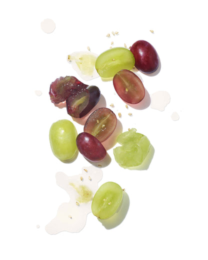 Sliced green and red grapes on a white background