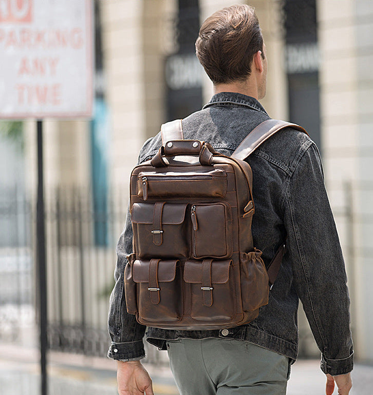 Man wearing a brown leather backpack on a city street