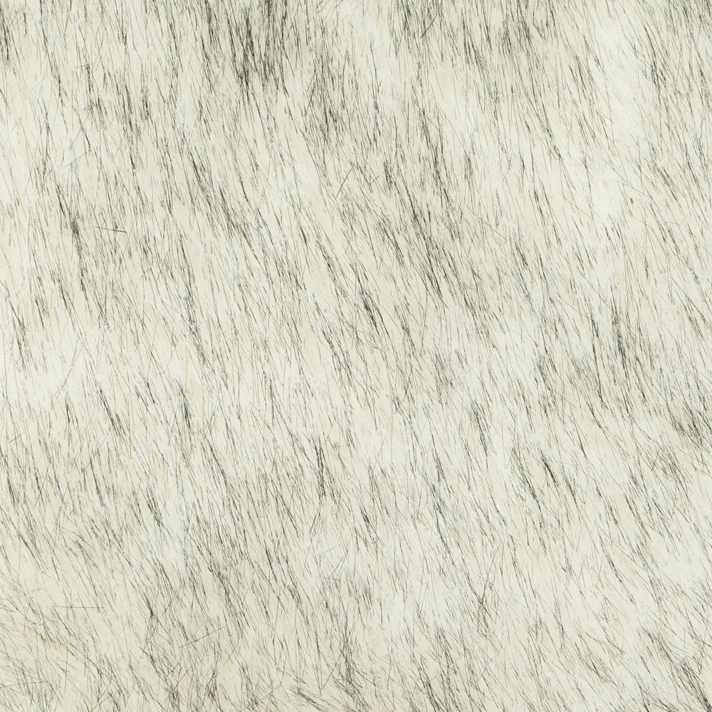 Close-up of a textured faux fur throw blanket surface with a neutral color palette