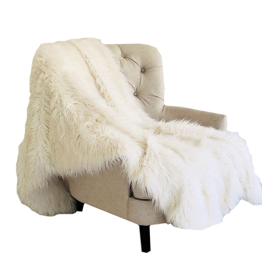 Beige armchair with a fluffy white throw blanket on a white background