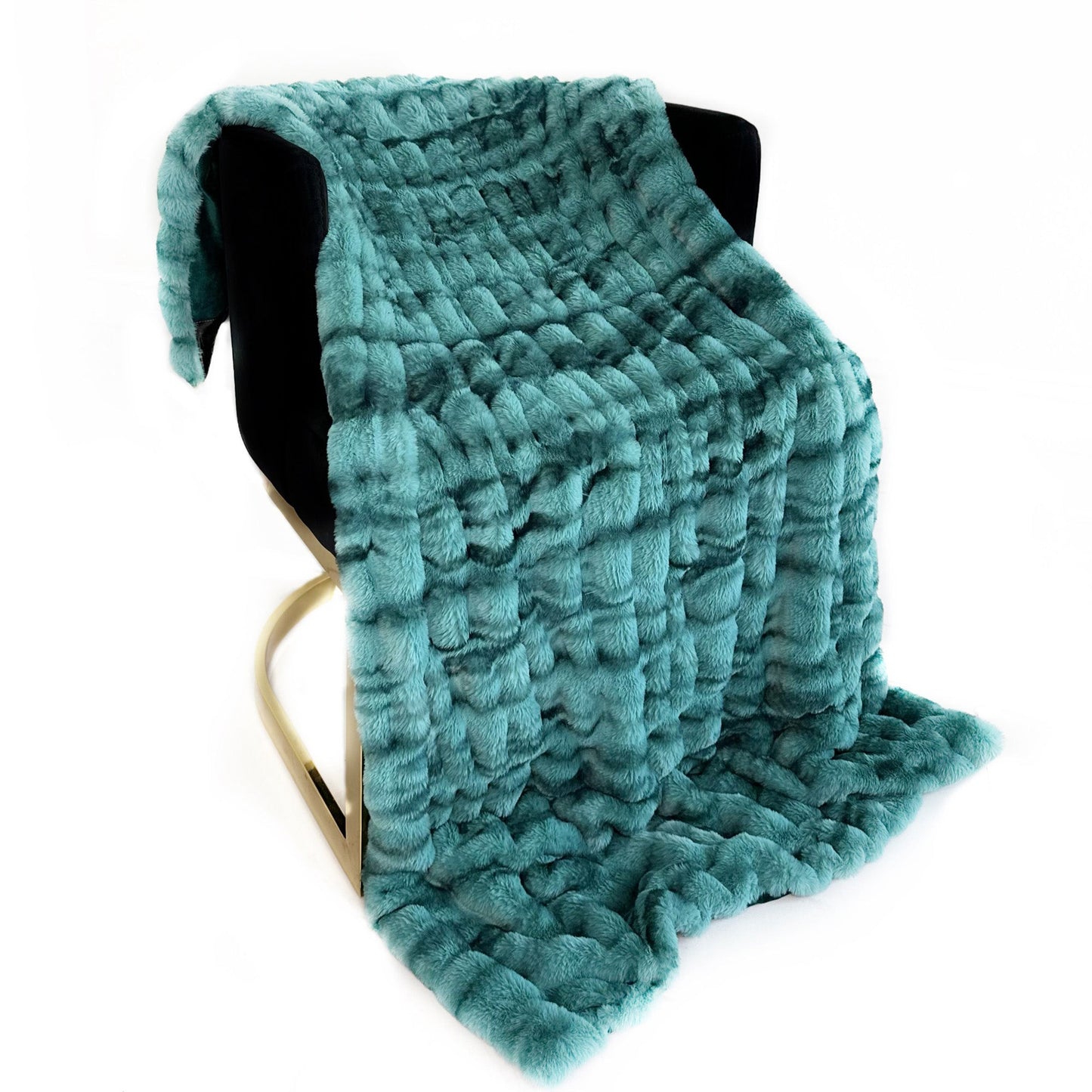 Teal textured blanket draped over a black chair on a white background