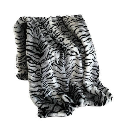 Black and white striped faux fur throw blanket on a white background