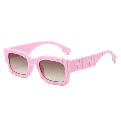 Pink sunglasses with a geometric pattern on a white background