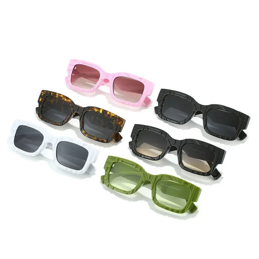 Five pairs of sunglasses with different colors and designs on a white background