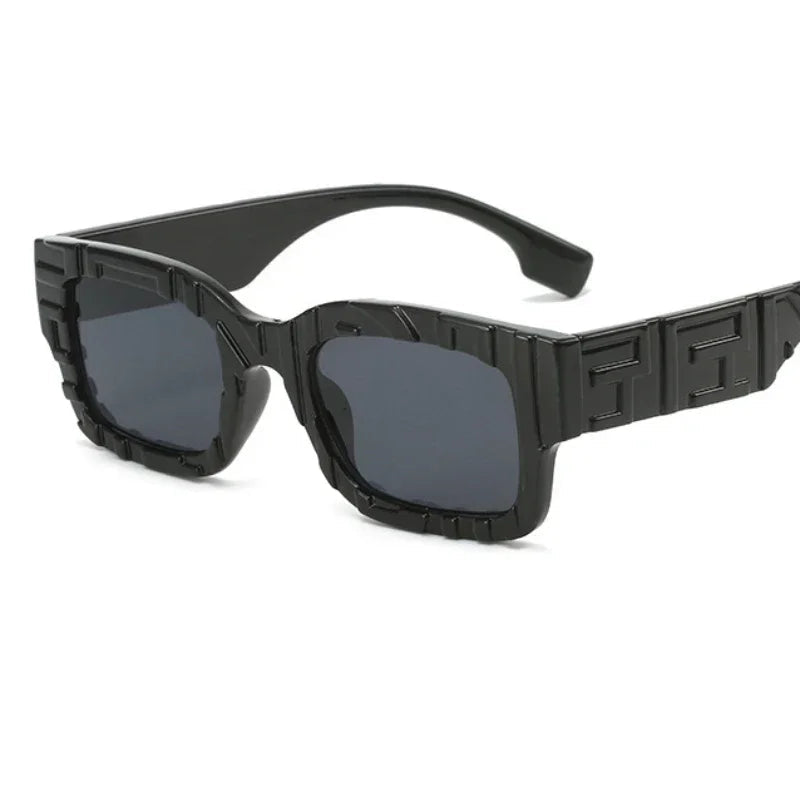 Black sunglasses with a geometric frame on a white background