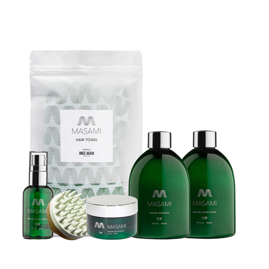 Set of Masami hair care products including shampoo, conditioner, serum, and towel on a white background
