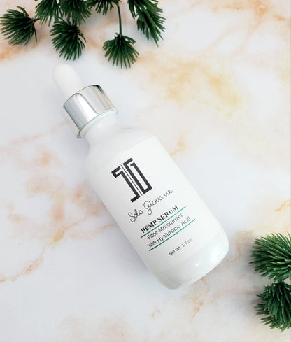 Solo Giovanne Skincare serum bottle on a marble surface with green leaves