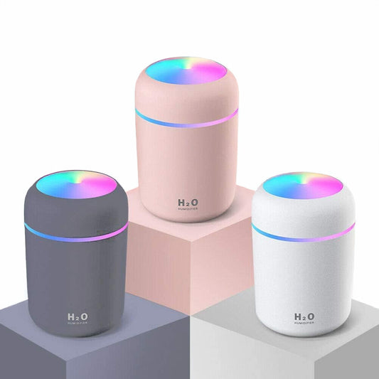Three Mini Air Humidifier & Aroma Oil Diffusers – Portable 300ml, USB Powered with colorful LED lights on a geometric background