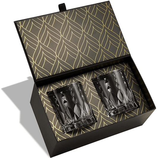 Two clear glass tumblers in a decorative black box with gold leaf pattern