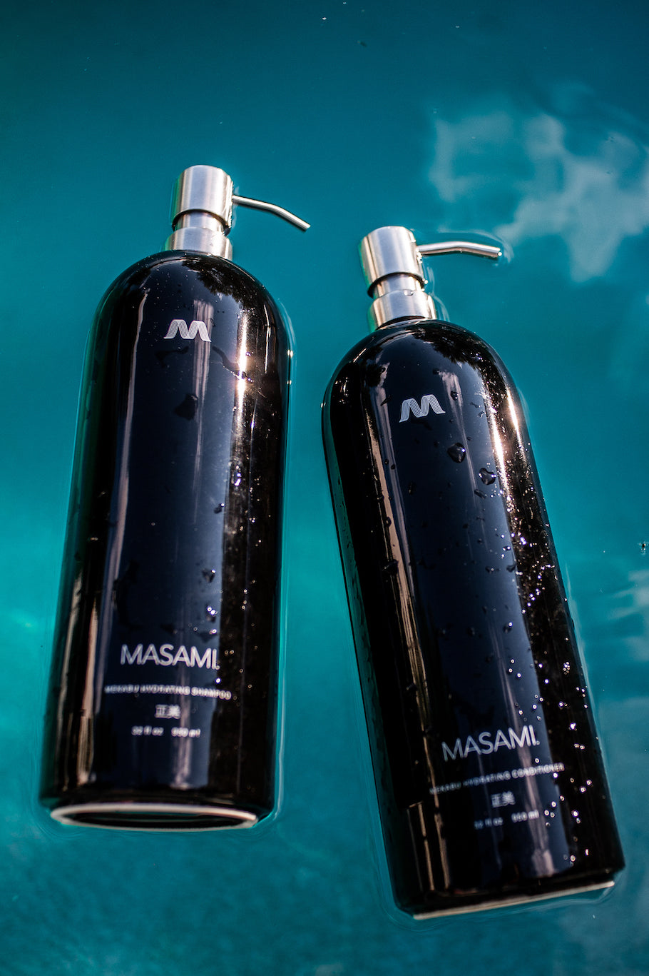 Two black bottles with silver pumps labeled 'MASAMI' on a blue background.