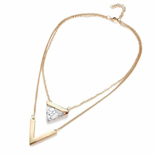 Gold necklace with a triangular pendant on a white background