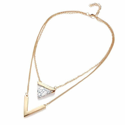 Gold necklace with a triangular pendant on a white background