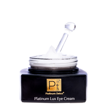 Platinum Lux Eye Cream jar with applicator on a white background