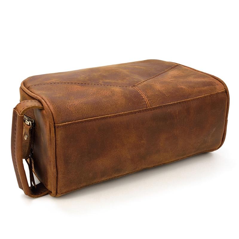 Brown leather toiletry bag on a white background