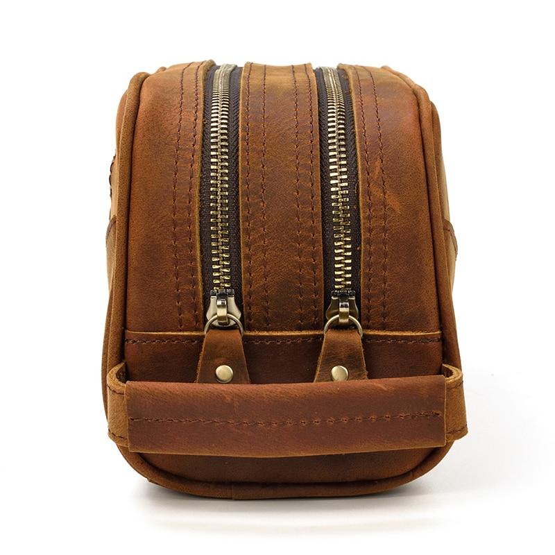 Brown leather backpack with two zippers on a white background