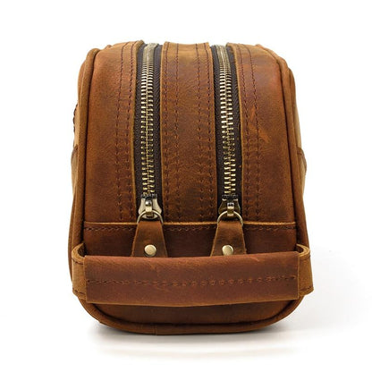 Brown leather backpack with two zippers on a white background