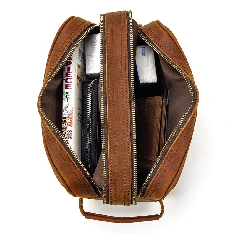 Brown leather bag with compartments on a white background