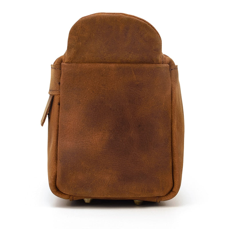 Brown leather toiletry bag on a white background