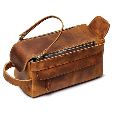 Brown leather bag with a handle on a white background