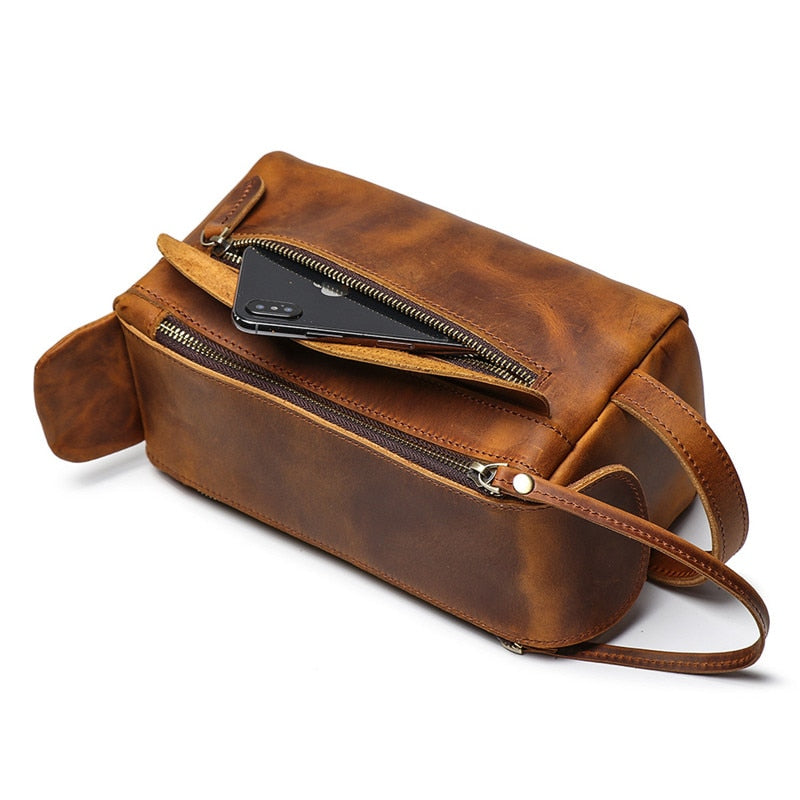 Brown leather bag with a zipper on a white background