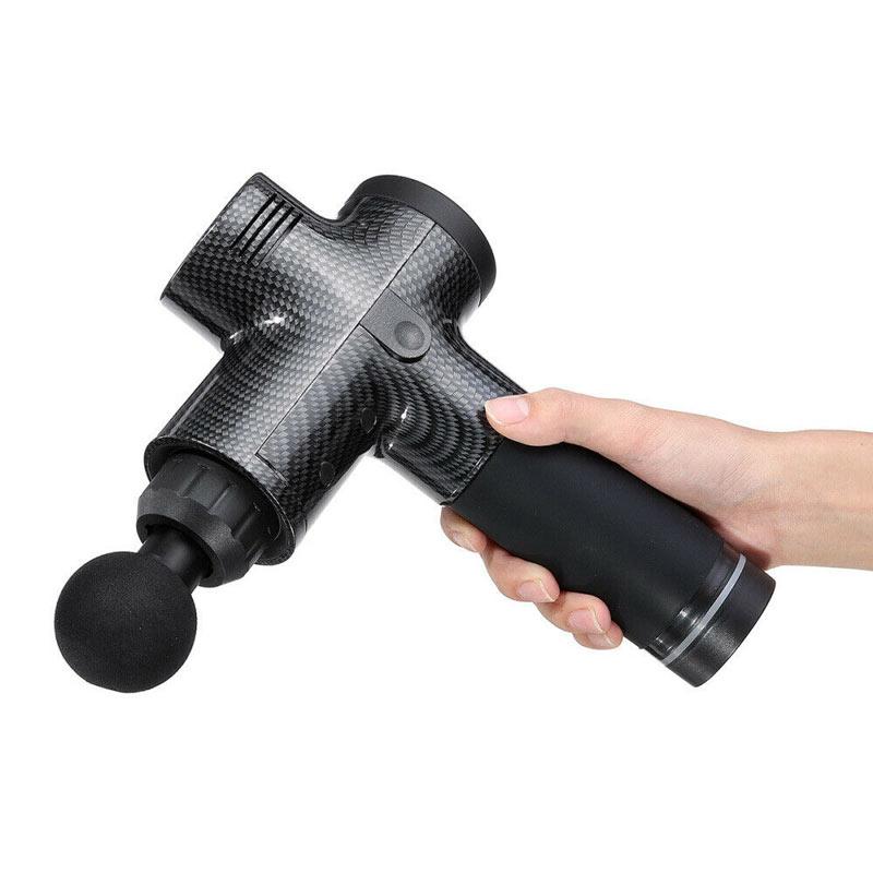 Hand holding a black massage gun on a white background