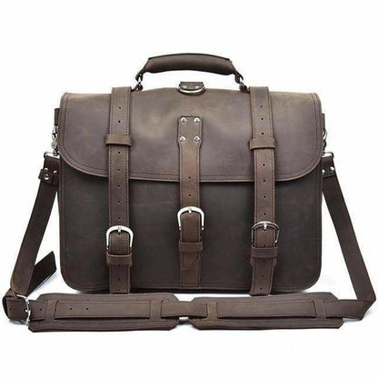 Brown leather satchel bag with straps and buckles on a white background