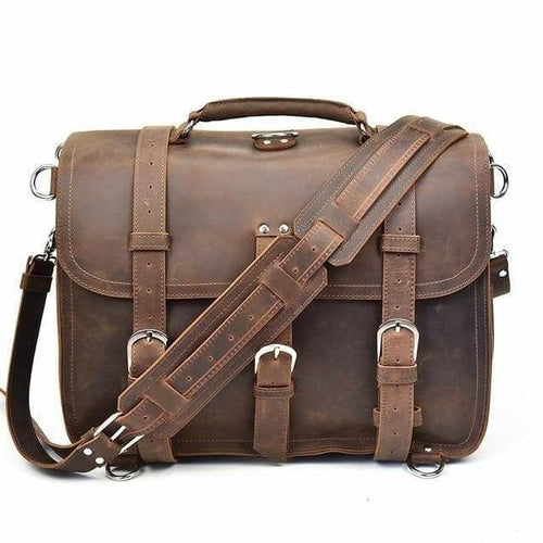 Brown leather satchel bag with strap on a white background
