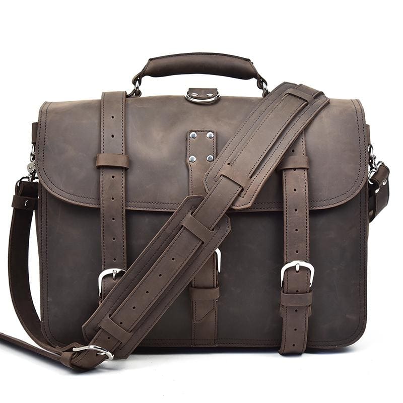 Brown leather satchel bag with a shoulder strap on a white background