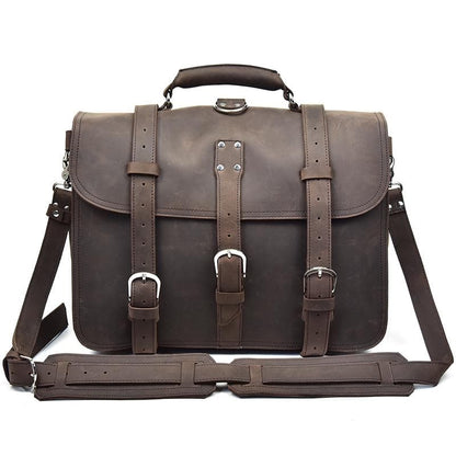 Brown leather satchel bag with straps on a white background