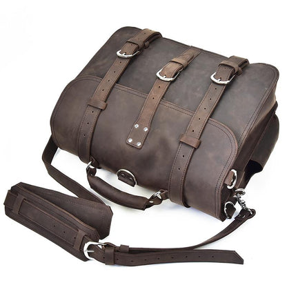 Brown leather bag with straps on a white background