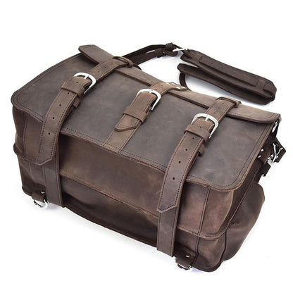 Brown leather satchel bag with straps on a white background