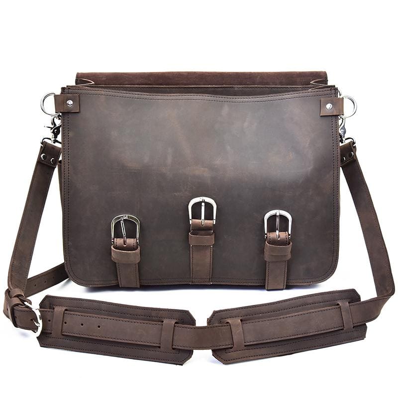 Brown leather bag with straps on a white background