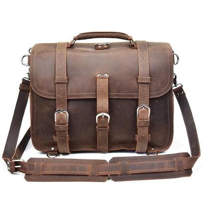 Brown leather satchel bag with straps on a white background