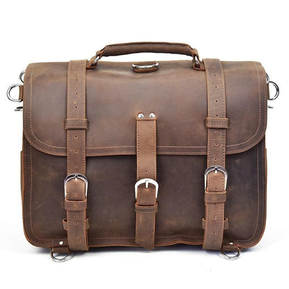 Brown leather satchel bag with straps and buckles on a white background